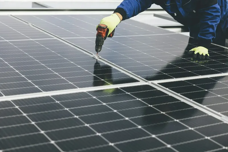 Technician servicing solar panels